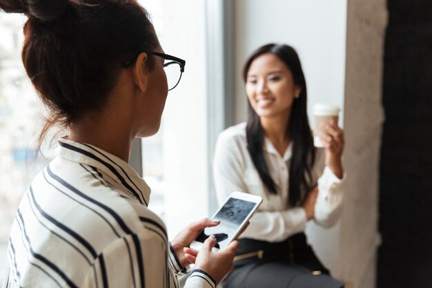 Businesswomen colleagues talking with each other