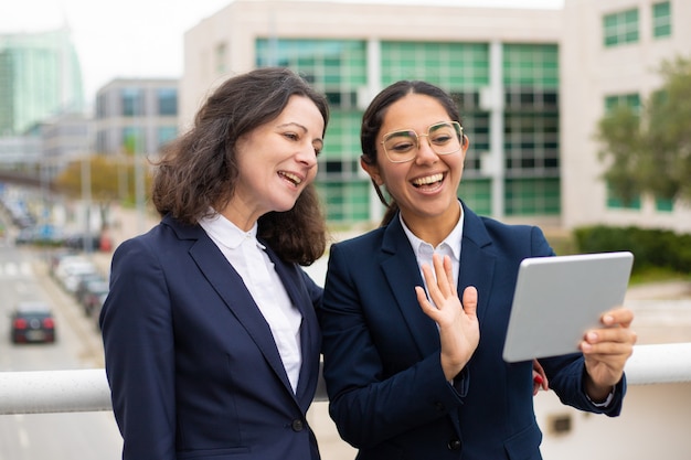 Businesswomen having video chat outdoors