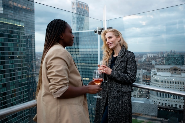 Businesswomen meeting outdoors for drinks