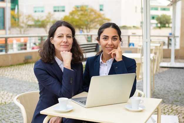 Businesswomen smiling in outdoor cafe