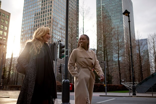 Businesswomen talking and walking together in the city