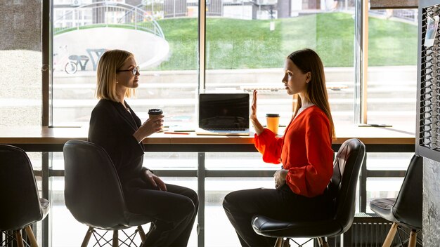 Businesswomen using sign language at work