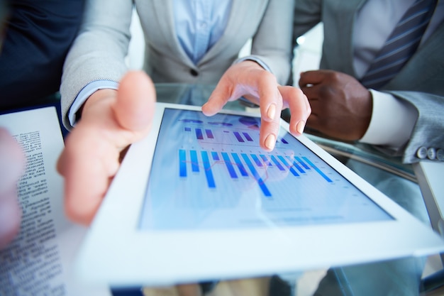 Busineswoman holding a digital tablet with data