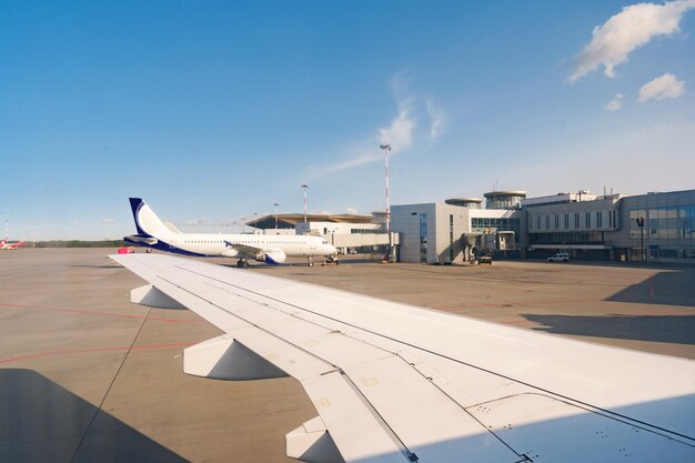 Busy airport view with airplanes against clear sky