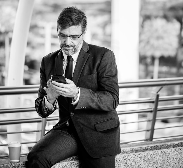 Free photo busy businessman using his phone