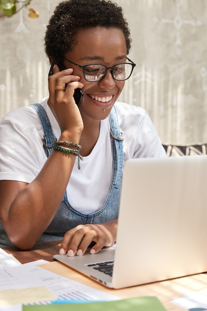 Busy cheerful copywriter works freelance at laptop computer