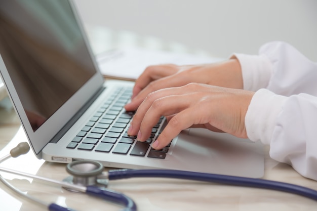 Busy doctor using her laptop