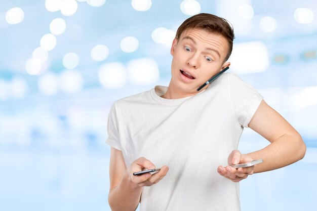 Busy man talking several phones same time