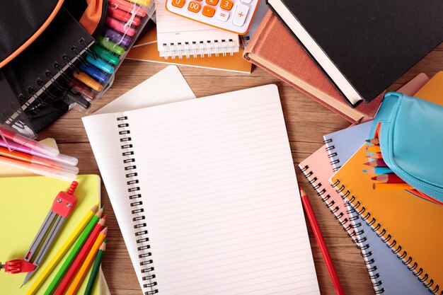 Busy students desk with open notebook 