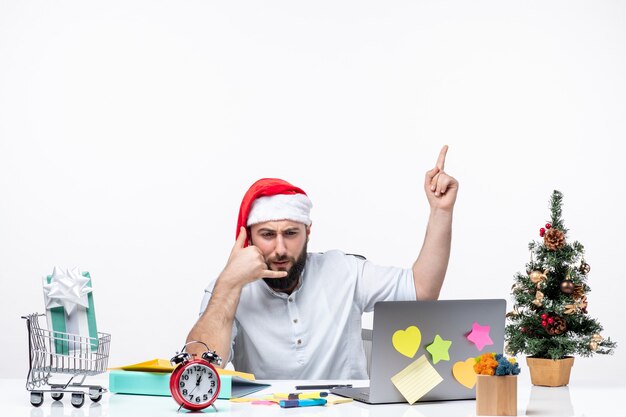 Busy young businessman with santa claus hat working