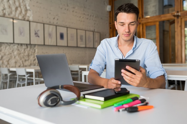 Busy young hadsome busy man concentrated on work in laptop