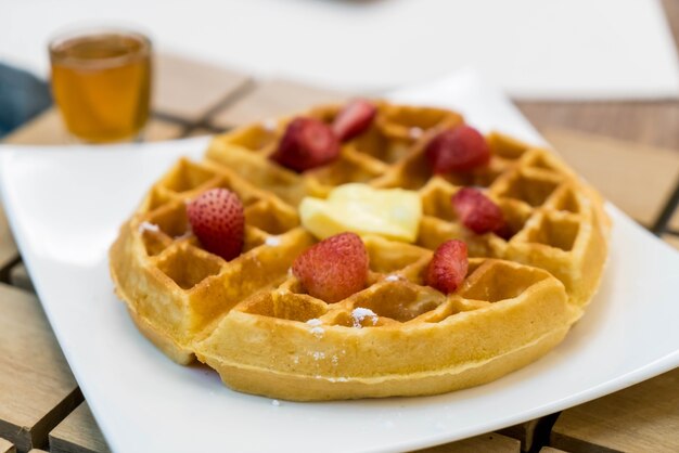 butter waffle with honey and strawberry