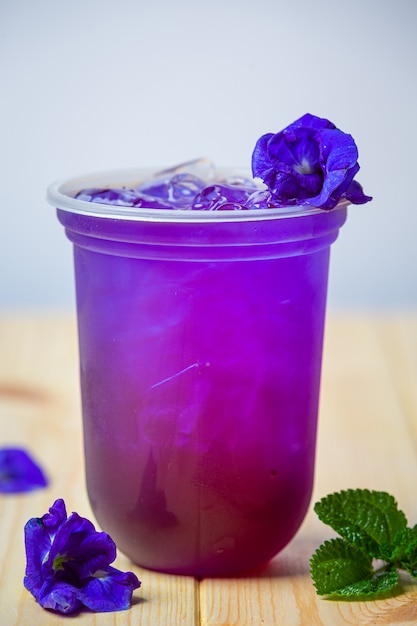 Butterfly pea juice with coconut on wooden surface