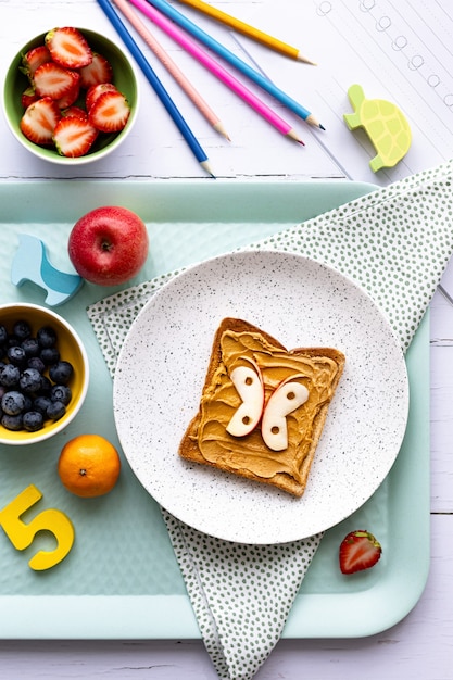 Free photo butterfly peanut butter toast, kids snack