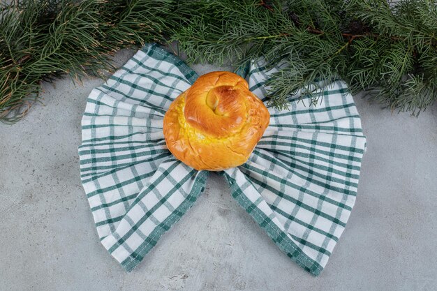 Butterfly shaped towel under a sweet bun on marble surface