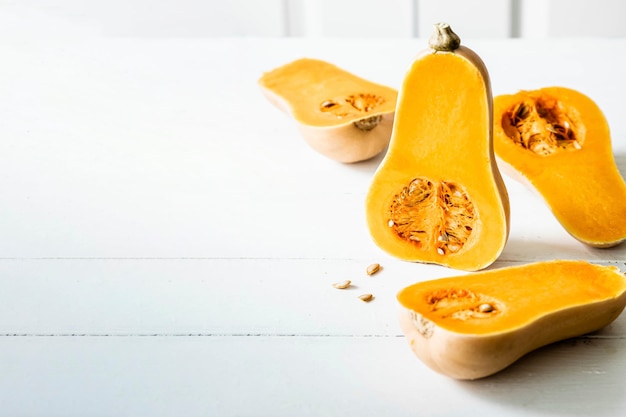 Butternut squash halves on white table