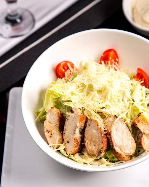 Caesar salad with chicken and grated parmesan