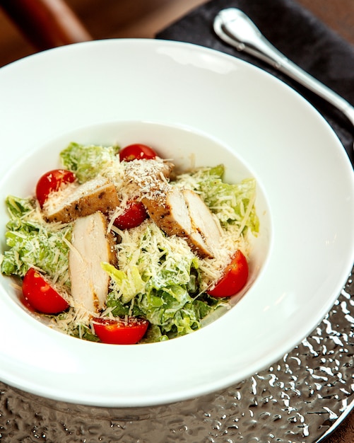 Caesar salad with chicken and grated parmesan
