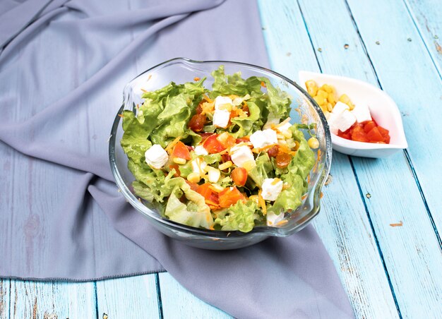 Caesar salad with lettuce leaves and black olives in a glass bowl