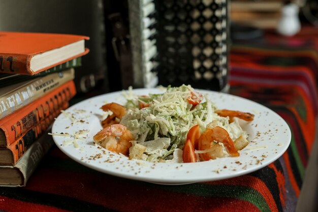 Caezar salad crackers parmesan tomato prawns anchovies side view