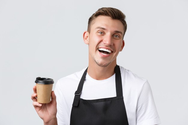 Cafe and restaurants coffee shop owners and retail concept friendly joyful handsome barista in black...