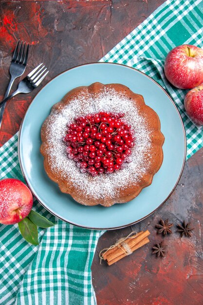 a cake a cake apples on the checkered tablecloth knife cinnamon forks