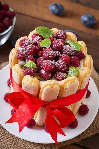 Cake "Charlotte " with raspberries and plums.