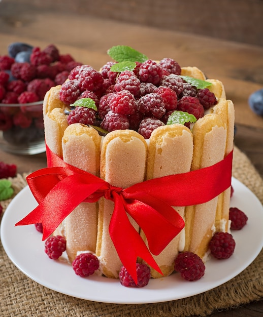 Cake "Charlotte " with raspberries and plums.