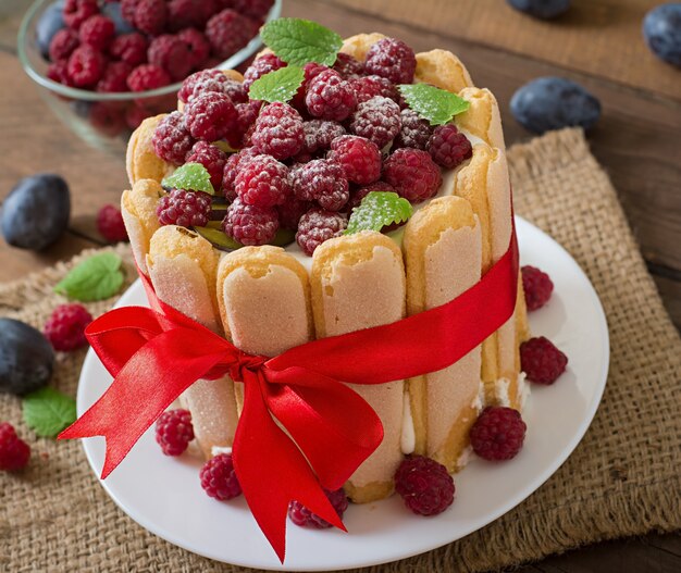 Cake "Charlotte " with raspberries and plums.