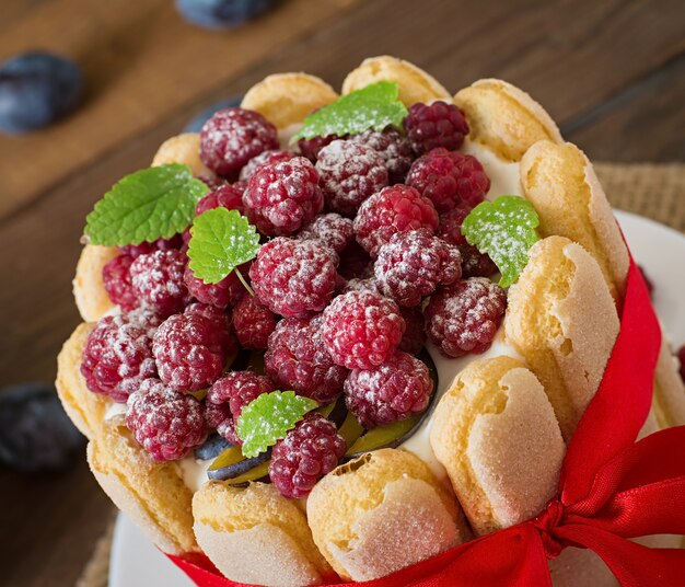 Cake "Charlotte " with raspberries and plums.