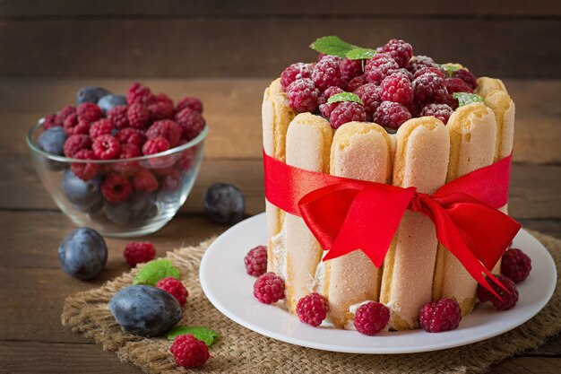 Cake "Charlotte " with raspberries and plums.