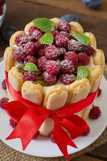 Cake "Charlotte " with raspberries and plums.