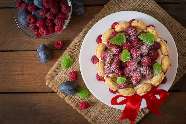 Cake "Charlotte " with raspberries and plums.