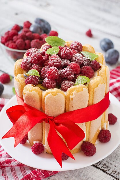 Cake "Charlotte " with raspberries and plums.