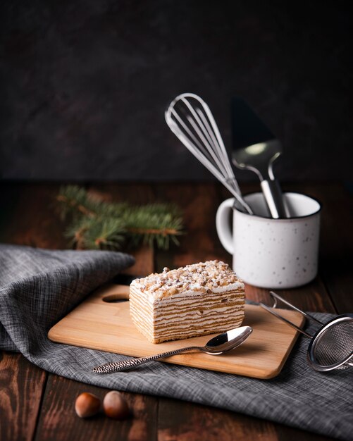 Cake on chopping board with spoon and chestnuts