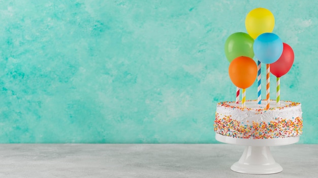 Cake and colorful balloons with copy space