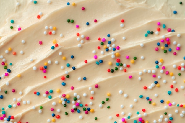 Free photo cake frosting texture background vector with sprinkles on top