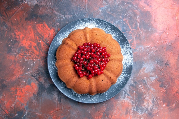 Бесплатное фото Торт тарелка аппетитного торта с красной смородиной на красно-синем столе