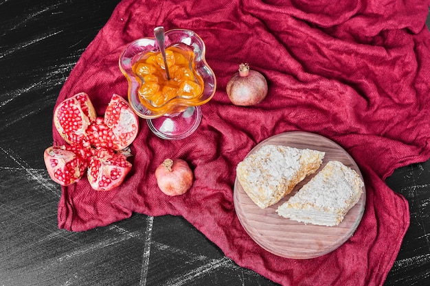 Cake slices and confiture on red towel