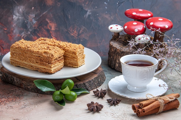 cake slices honey cake with cup of tea on grey