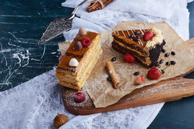 Cake slices on a wooden board. 