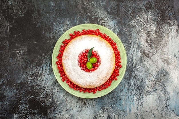 cake with berries an appetizing cake with seeds of pomegranate on the plate