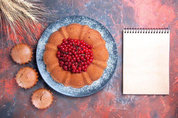 cake with berries a cake with berries cupcakes and wheat ears notebook