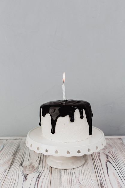 Cake with candle on plate