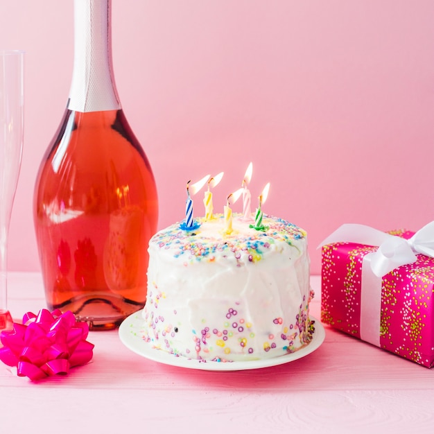 Cake with candles and champagne