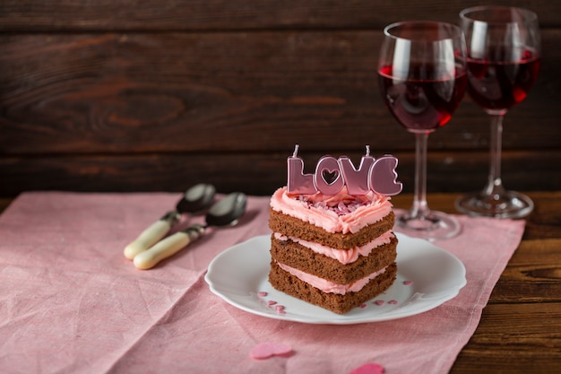 Cake with candles and wine glasses