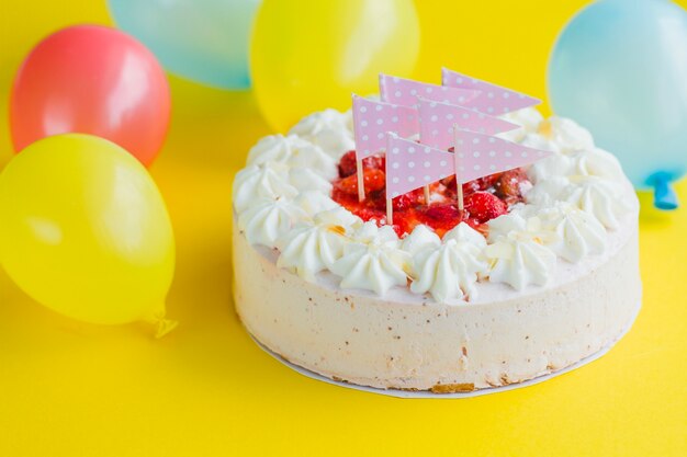 Cake with festive flags and balloons