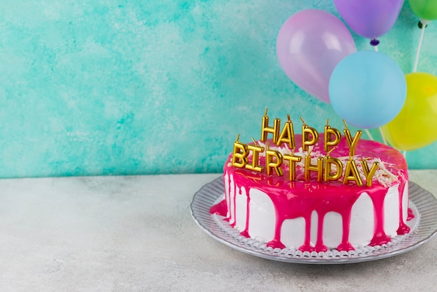 Cake with glaze and candles high angle