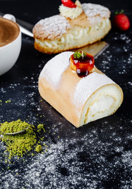 Cake with powdered sugar and cup of cappuccino on the table