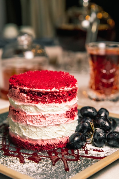 Cake with red topping and grapes